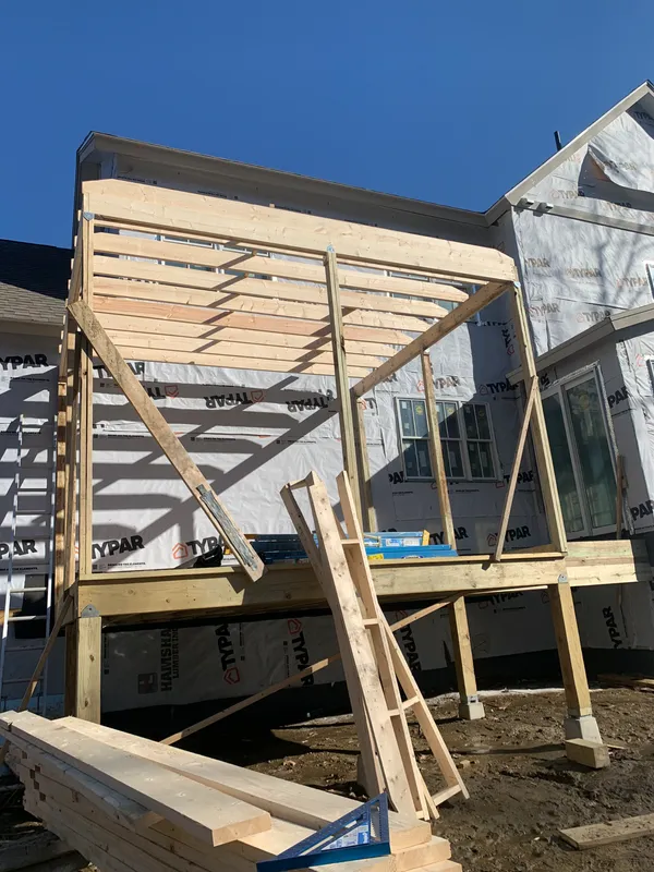 Wooden frame of a house under construction with Typar house wrap.